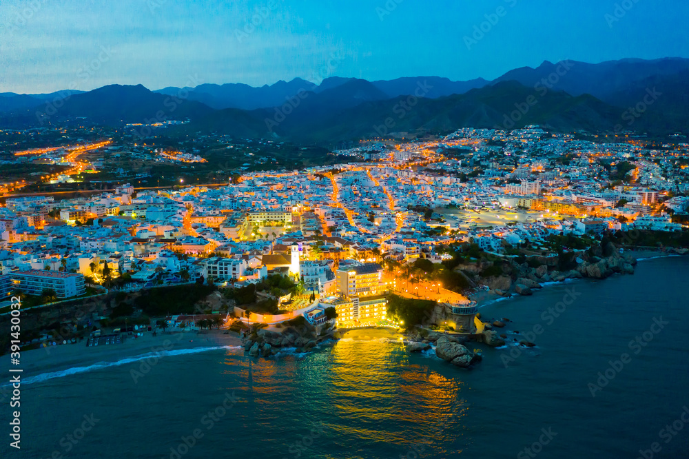 Aerial view of Nerja city with coastline in province of Malaga at night, Andalusia, southern Spain