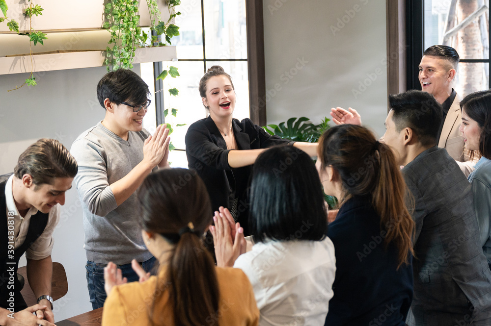 The corporate of employees group forming a stack of hands on the desktop with the leader manager for succeed project The corporate of employees group forming a stack of hands on the desktop with the leader manager for succeed project
