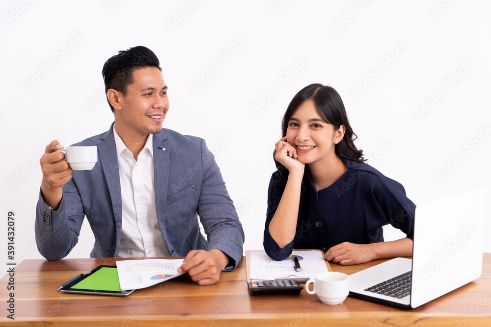 portrait of a business partner who is calculating his business profits and working on a laptop. Relax with a coffee at it modern office desk portrait of a business partner who is calculating his business profits and working on a laptop. Relax with a coffee at it modern office desk
