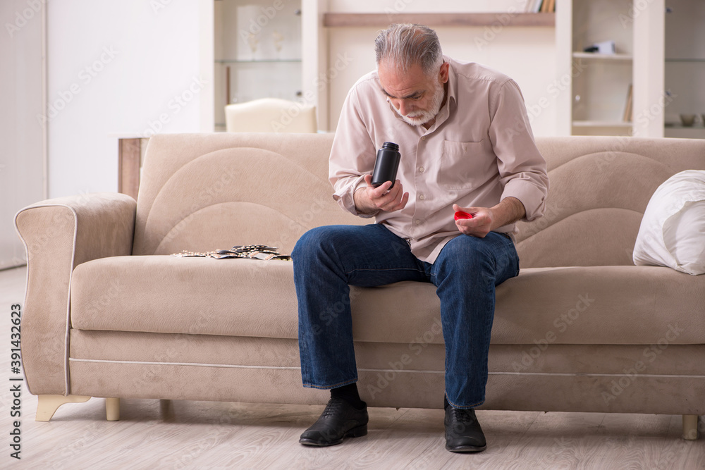 Old sick man suffering at home Old sick man suffering at home