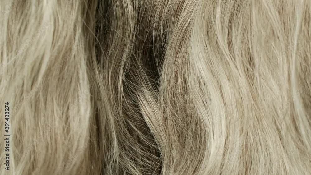 Slow motion of beautiful blond grey long smooth curly hair texture background. Slow motion of beautiful blond grey long smooth curly hair texture background.