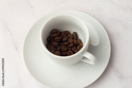 white cup with coffee beans.