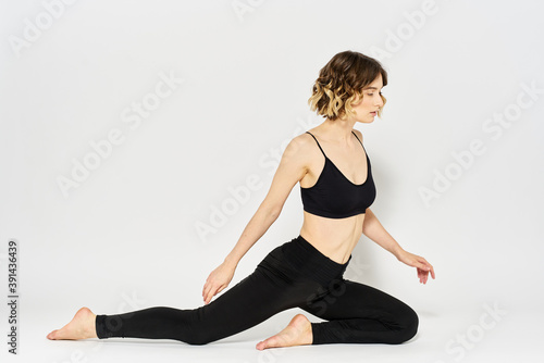 woman in dark clothes sitting on the floor and meditation exercises for legs leggings