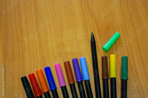 Multi-colored Meiji pens on the wooden floor table