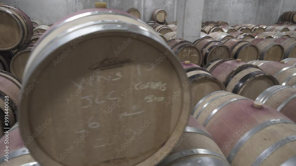 Many wooden barrels full of red wine in a modern winery, wine cellar Many wooden barrels full of red wine in a modern winery, wine cellar