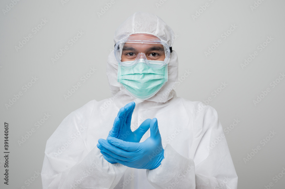 A portrait of virologist Wearing PPE suit clap his hand look into camera isolated on white background. Personal Protective Equipment Concept. A portrait of virologist Wearing PPE suit clap his hand look into camera isolated on white background. Personal Protective Equipment Concept.