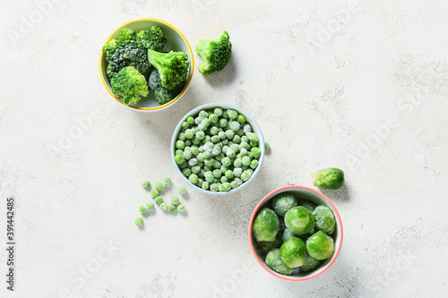 Fototapeta Naklejka Na Ścianę i Meble -  Bowls with different frozen vegetables on white background