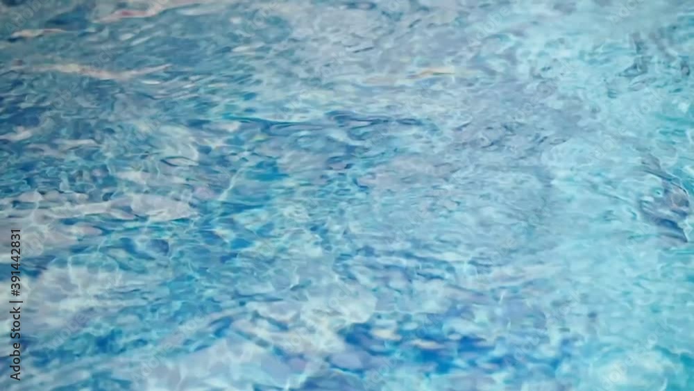 flowing water in swimming pool with underwater jet system making ripple on surface flowing water in swimming pool with underwater jet system making ripple on surface