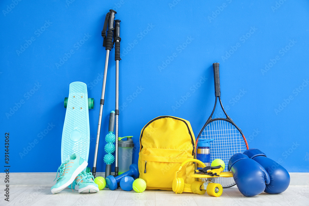 Set of sport equipment on floor near color wall - obrazy, fototapety, plakaty 