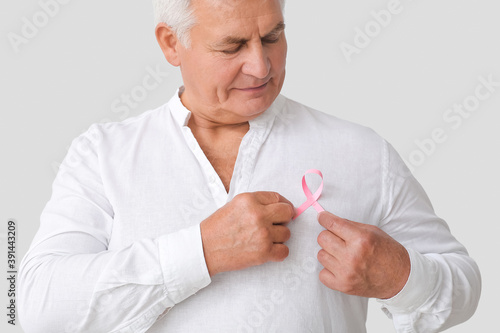 Mature man with pink ribbon...