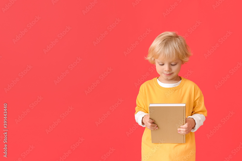 Cute little boy with book on color background Cute little boy with book on color background
