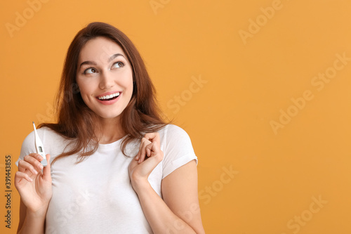 Young woman with thermomete...