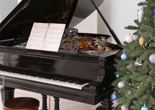 Grand piano in room decorated for Christmas