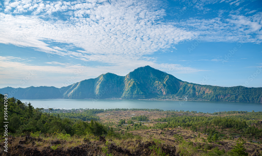 Panorama of popular trek destination Mount Batur eastern ridge at sunrise, with Danau Batur crater lake in Bali, Indonesia Panorama of popular trek destination Mount Batur eastern ridge at sunrise, with Danau Batur crater lake in Bali, Indonesia