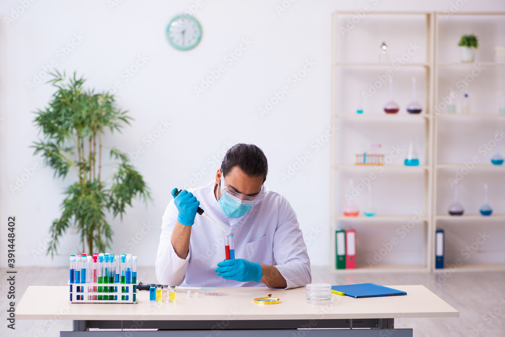 Young male chemist working in the lab Young male chemist working in the lab