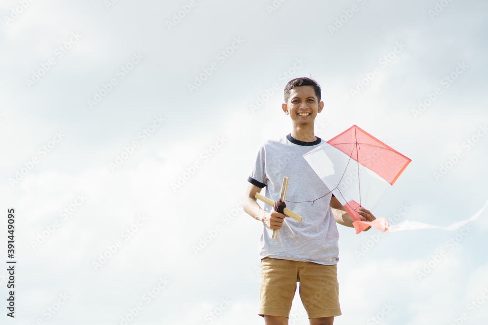 portrait young man ready playing kites in the fields