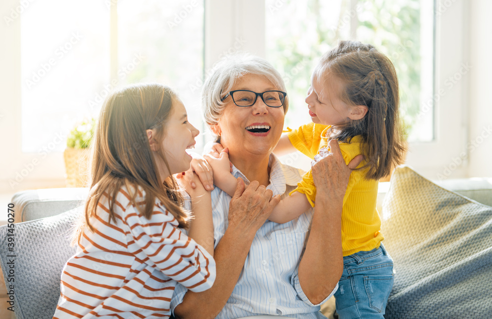 girls and their grandmother enjoying sunny morning