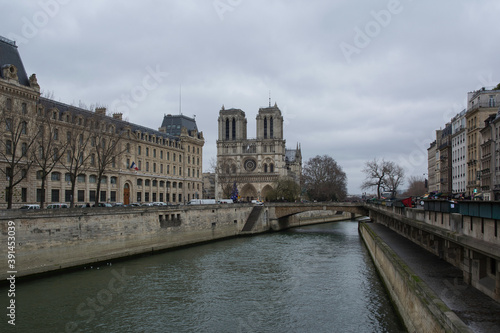 View of the river Seine on a cloudy morning with Notre Dame in the background. Paris, France.