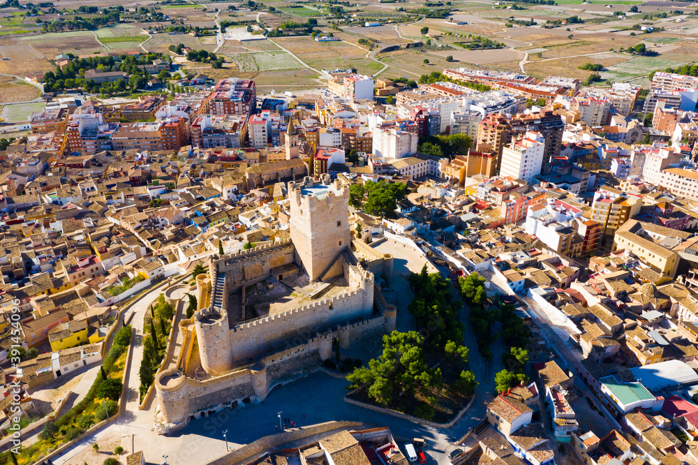 Scenic view from drone of houses and old Castle de Atalaya of Villena town at sunny day, Spain