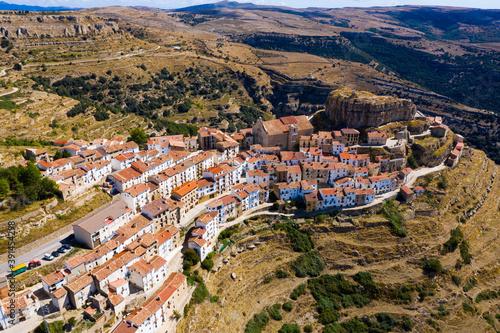 View from drone of Ares del Maestrat, small ancient town on mountain slopes on sunny fall day, Spain photo