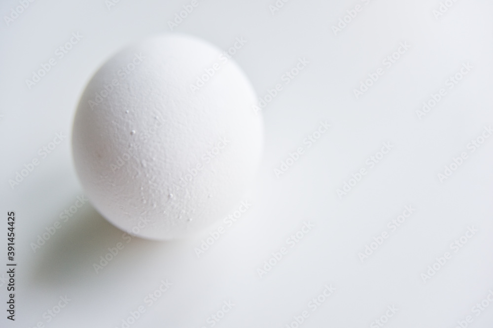 selective focus at the white egg in the hand selective focus at the white egg in the hand