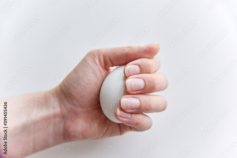 selective focus at the white egg in the hand selective focus at the white egg in the hand