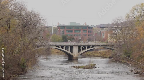 Stone bridge crossing a dark fast river. The bridge crossing Chippewa River in Eau Claire, Wisconsin