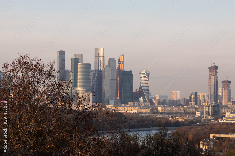 View from Vorobyevy gory or Sparrow Hills on the Moscow city business center in the autumn evening. It is a modern complex of skyscrapers on the Moskva River embankment. View from Vorobyevy gory or Sparrow Hills on the Moscow city business center in the autumn evening. It is a modern complex of skyscrapers on the Moskva River embankment.