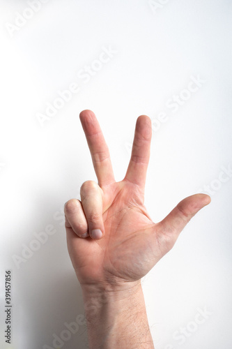 man hand on white background pointing three with fingers. © Luca