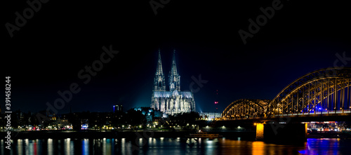 Long exposure of the city harbour bridge in Cologne at night showing also the famous cathedral