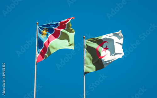 Beautiful national state flags of Namibia and Algeria together at the sky background. 3D artwork concept.