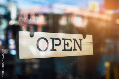 A business sign that says ‘Open’ on cafe or restaurant hang on door at entrance.