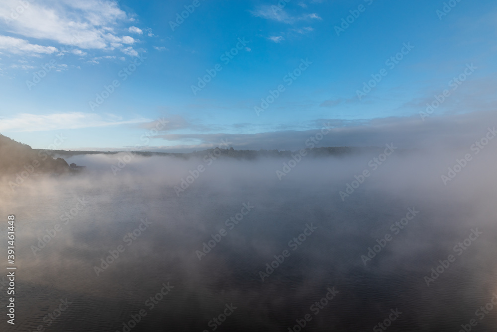 Autumn misty morning with blue sky above on Vranovska prehrada in Czech republic