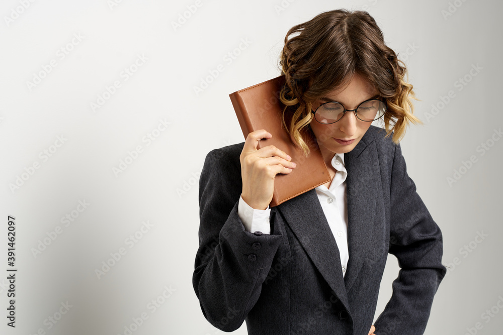 business woman in a suit with documents in hands light background curly hair hairstyle business woman in a suit with documents in hands light background curly hair hairstyle