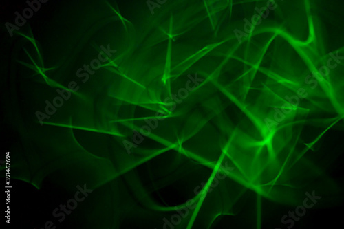 Futuristic dark background with blurred motion green glow