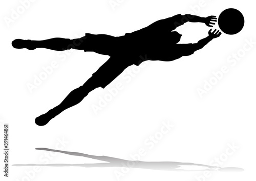 A soccer or football player in silhouette
