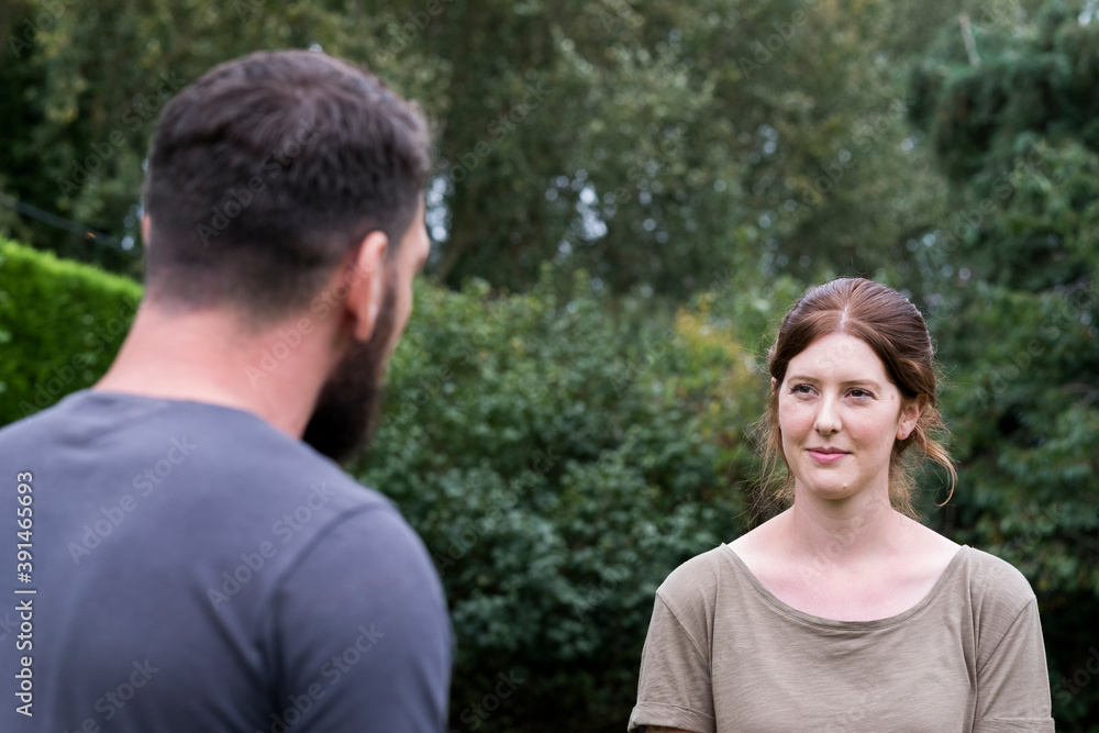Therapist and client talking in a garden, man and woman Therapist and client talking in a garden, man and woman