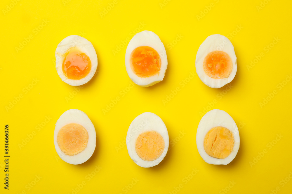 Hard boiled eggs on yellow background, top view Hard boiled eggs on yellow background, top view