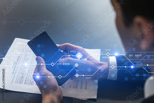 Canvas Print Businessman in office working with Smartphone, new technologies hologram to optimize the process, typing phone