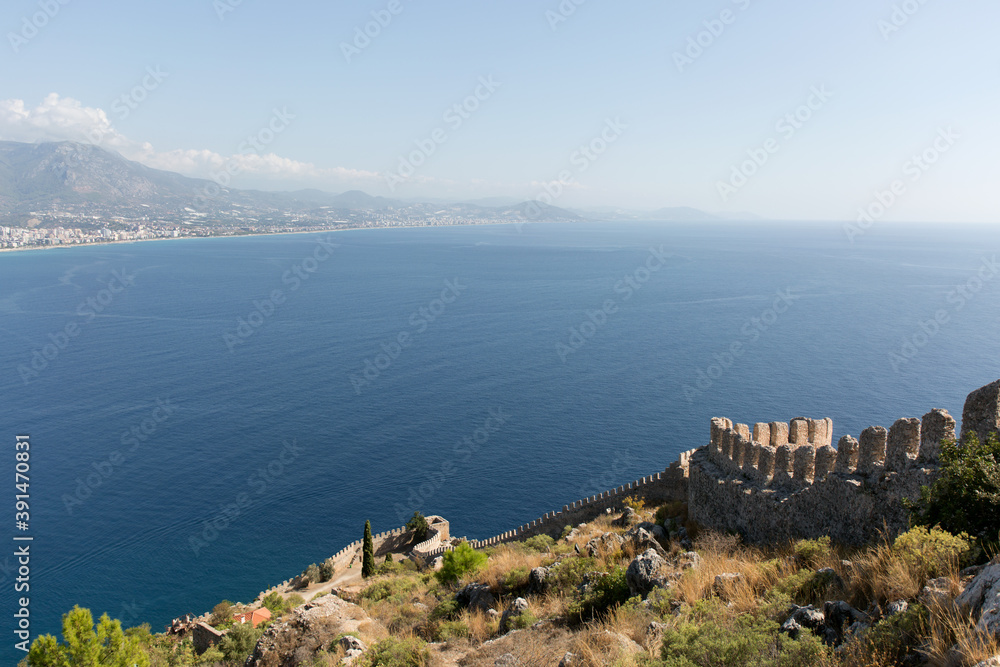 Old fortress stone wall on blue sea background.