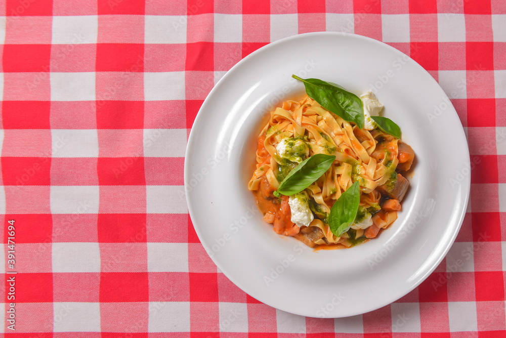 Italian penne pasta or noodles with a savory tomato sauce, fresh basil and grated parmesan cheese. Italian penne pasta or noodles with a savory tomato sauce, fresh basil and grated parmesan cheese.