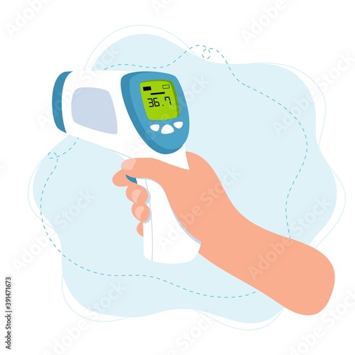 Body temperature check, hand holding infrared thermometer.