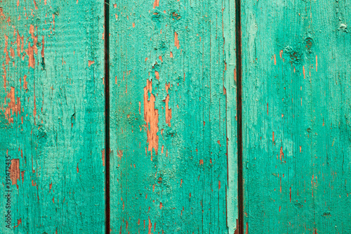 Weathered blue wood background texture. Worn turquoise or turquoise-green wood is painted. Vintage wooden background.