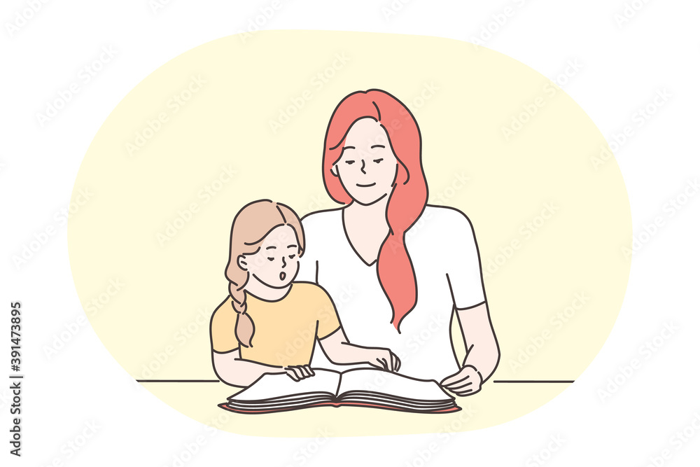 Happy leisure and activities at home with children concept. Young woman mother cartoon character reading, learning letters or words together with her small daughter at home. Relax, rest, family