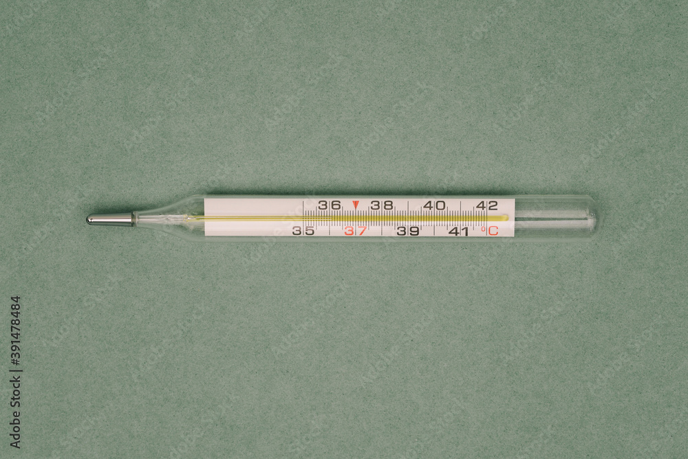 Glass mercury thermometer. Medical instrument for measuring human body temperature. Research concept for patients with covid-19 and other infections Glass mercury thermometer. Medical instrument for measuring human body temperature. Research concept for patients with covid-19 and other infections