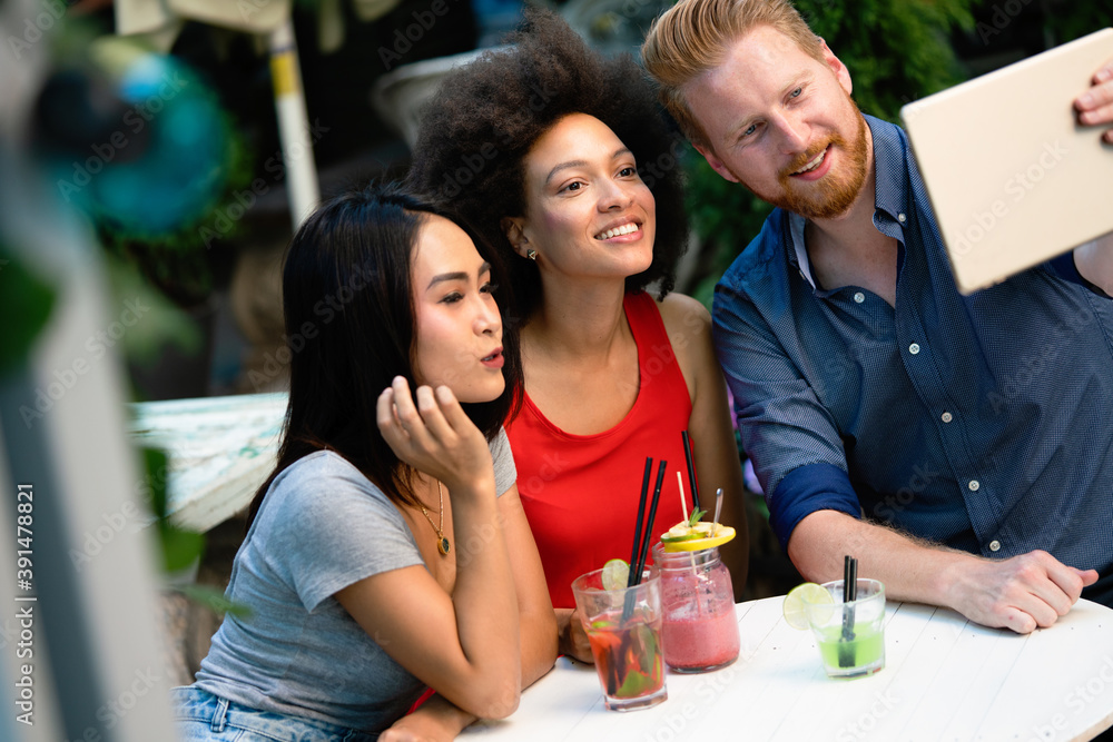 Diverse group of happy friends having fun, talking in cafe outdoor at summer Diverse group of happy friends having fun, talking in cafe outdoor at summer