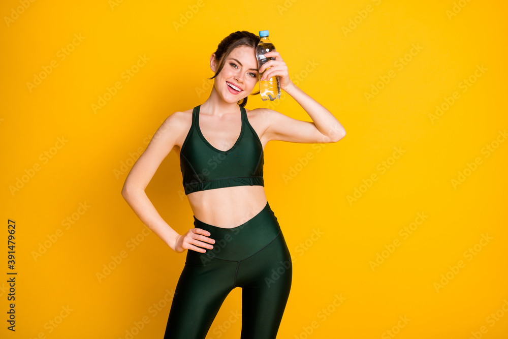 Fototapeta premium Portrait of her she nice attractive cheerful thin girl drinking fresh water resting isolated on bright yellow color background