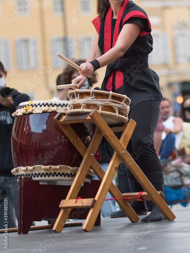 Girl Playing Drums of Japanese Musical Tradition during a Public Outdoor Event
