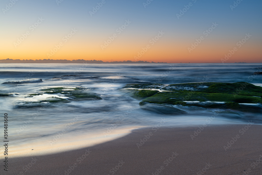 Clear skies and soft seas, dawn at the beach