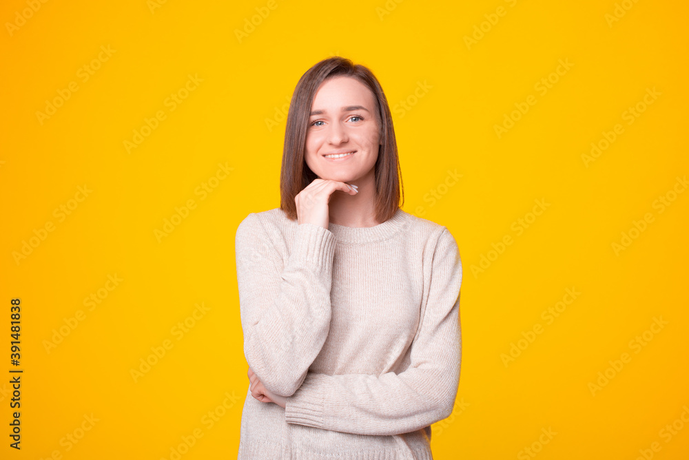 Portrait of a beautiful young woman near a yellow wall . Portrait of a beautiful young woman near a yellow wall .